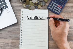 How does debt factoring improve cash flow